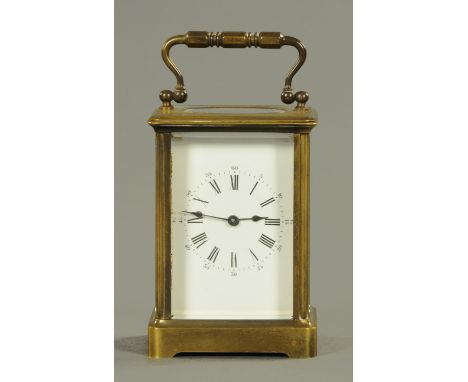 An Edwardian brass cased carriage clock, timepiece only.  Height excluding carrying handle 11 cm.   CONDITION REPORT: The clo