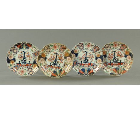 A set of four Japanese Imari dishes, late 17th / early 18th century, of moulded sixteen petal chrysanthemum shape centred wit