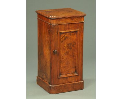 A Victorian walnut bedside cabinet, with rounded corners and panelled cupboard door opening to shelves.  Width 40 cm. CONDITI