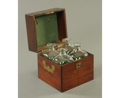 A George III mahogany square decanter box, containing four decanters.  Width 21 cm.  CONDITION REPORT: The casket itself is i