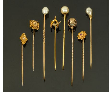 Eight Victorian stick pins, to include a 9 ct gold example with a wishbone and seed pearl set crescent, three mounted with pe