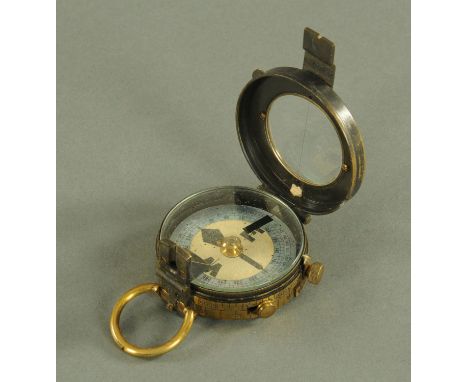 A Verners pattern military brass compass, struck on the underside "The Soho M&amp;S Inst. Works. London No. 2097, dated 1906.