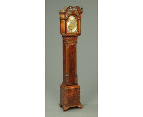 An Edwardian mahogany grandmother clock, in the Chippendale style, with swans neck pediment above the arched silvered brass d