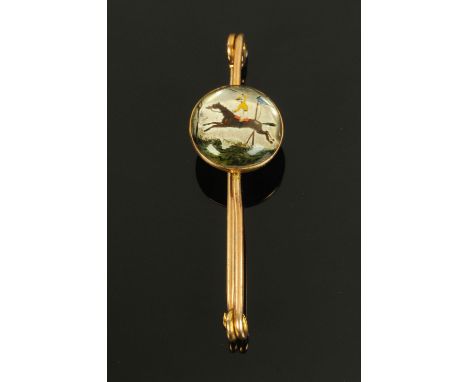 A 9 ct gold stick pin, with applied roundel depicting a mounted jockey.