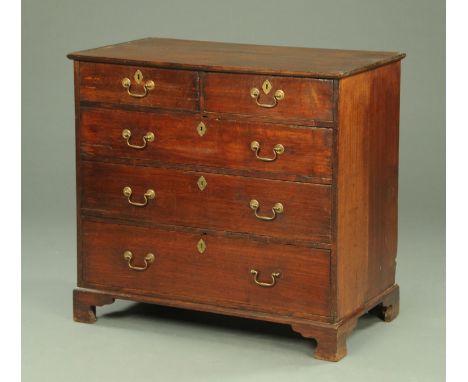 A George III oak chest of drawers, with two short and three long graduated drawers with brass drop handles and lock escutcheo