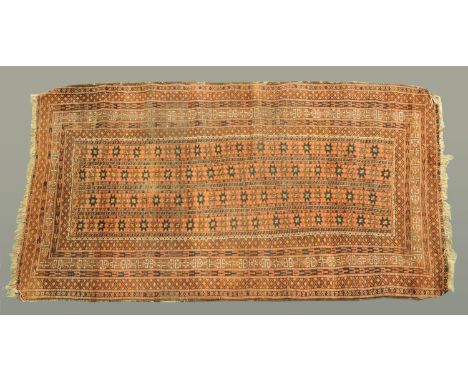 A Turkoman rug, the rectangular centre panel with four rows of repeating designs and with multiple line border and fringed en