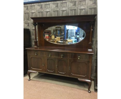 EARLY 20TH CENTURY MAHOGANY MIRROR-BACKED SIDEBOARD with overhaning moulded dentil cornice on two corinthian pillar supports,
