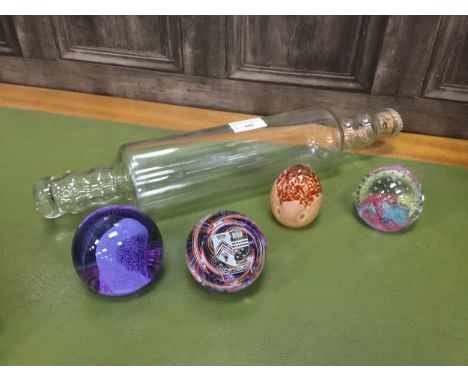 FOUR GLASS PAPERWEIGHTS, along with a glass rolling pin