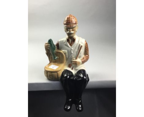 BALLANTYNES NOVELTY DECANTER, modelled as a sitting man holding a basket of fish, 36cm high, along with two art pottery plate