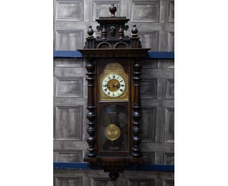 LATE VICTORIAN VIENNA WALL CLOCK, with twin train movement, the white enamel dial with Roman numerals, the pillared mahogany 