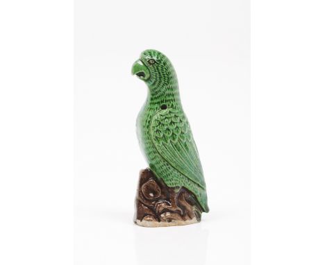 A parrotChinese porcelain sculpture depicting parrot on rock outcrop Polychrome decoration in shades of green and brown Kangx