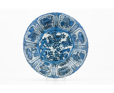 A large scalloped plateChinese porcelain Blue decoration with central landscape with flowers Cartouche decoration to lip with