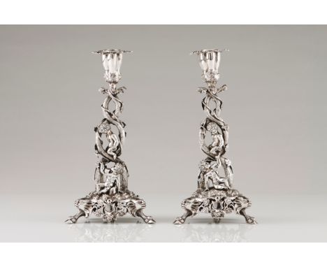 An unusual pair of candlestandsPortuguese silver, 19th century Profuse Romantic era decoration of putti playing in vineyards 