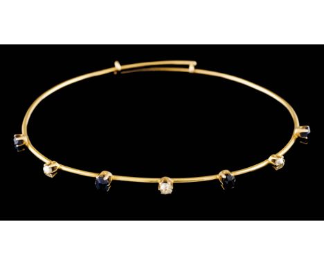 A braceletGold Extending bangle set with 4 small round cut sapphires and 4 small antique brilliant cut diamonds Later marked 