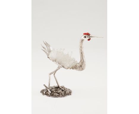 A long legged birdSilver and quartz crystal Moulded, scalloped and engraved decoration withe applied dyed shell comb and glas