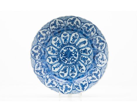 A large scalloped plateChinese porcelain Blue decoration with central flower motifs Cartouche decoration to lip with flowers 