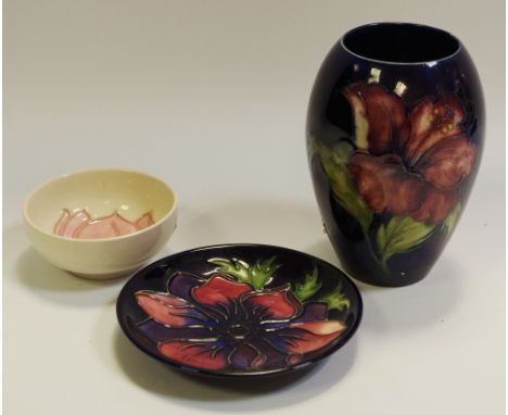 A Moorcroft Magnolia pattern pin dish; another smaller; an ovoid vase (3)