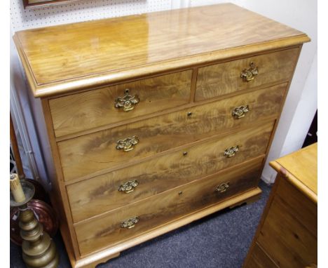 An early Victorian flamed mahogany chest of two short above three long drawers, brass batwing escutcheons with drop swing han