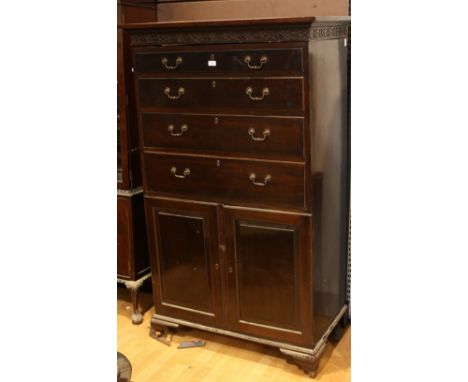 A Chinese Chippendale Revival chest, oversailing top with blind fretwork frieze above four long drawers and a pair of raised 