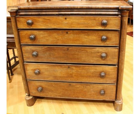 A Victorian mahogany 'Scotch' chest, shaped rectangular top above five long graduated cockbeaded drawers, flanked by near-cyl