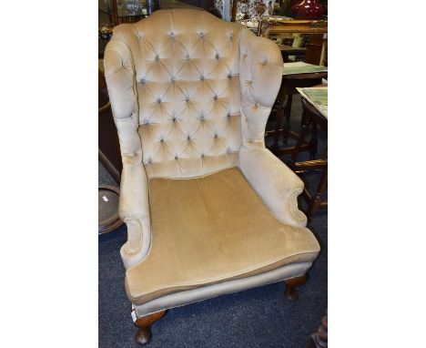 A George III wingback armchair, deep button backed, pale gold upholstery, c.1800, 112 cm x 80 cm x 90 cm