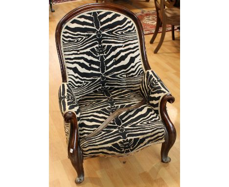 A Victorian mahogany framed nursing chair, button back, scroll arms, cabriole legs, scroll forefeet, later upholstery *** Ple