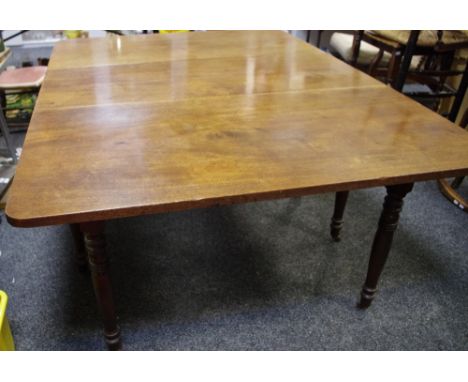 An early 19th century drop leaf dining table, turned legs, ceramic casters, 73cm high x 124cm wide x 52cm opening to 167.5 cm