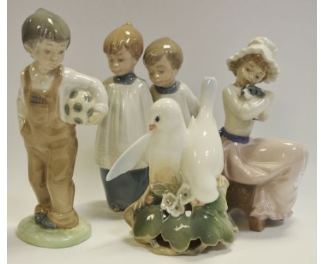 A Nao pottery figure, Boy with a Football; others, Choir Boys and Girl with Puppy, impressed and printed marks; a Royal Copen