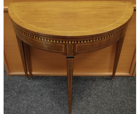 An Edwardian mahogany card table, fold over D top opening to circular green baize playing surface, tapering square legs, cheq