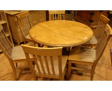 A pine kitchen table, circular top, triform base, 106.5cm diameter; A contemporary light oak effect drawleaf dining table; a 