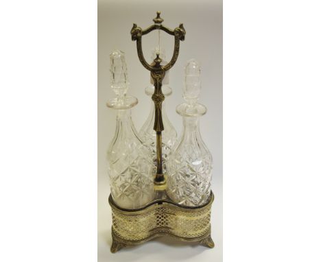 A Victorian plated trefoil decanter stand, with three cut glass decanters, 60cm high over handle