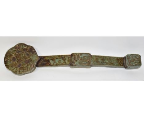 A Chinese jade ceremonial ruyi scepter, carved in the archaic manner with characters, stylized foliage and scrolls, 38cm long