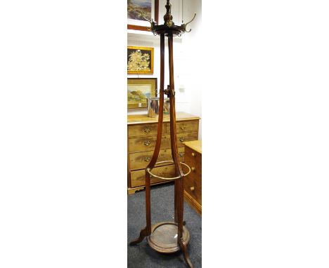 A late Victorian mahogany hall stand surmounted by turned finial above five brass hat hooks, fluted out splayed supports with