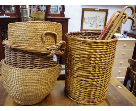 A two handled wicker log bin;  a pair of wicker log bins;  a wicker stick stand and sticks;  etc Provenance: From the Estate 