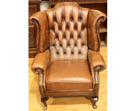 A Chesterfield type reception wingback office chair, deep button back, scroll arm, 111cm high *** Please note this lot may be