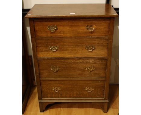 An early-mid 20th century oak chest of four long drawers, bracket feet, 105cm high
