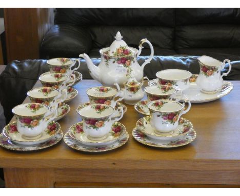 A Royal Albert 'Country Roses' tea service to include, eight cups, nine saucers, three side plates, milk jug, sugar bowl, pla