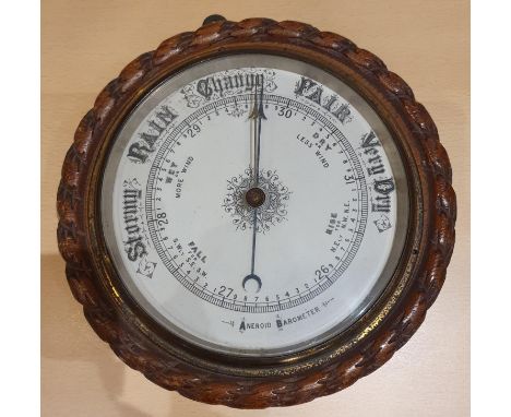 An Edwardian oak rope twist Aneroid barometer and other mantle clocks