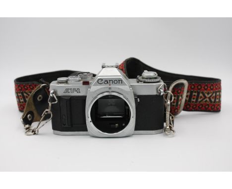 Canon AV-1 35mm SLR Film Camera (Body ONLY)  The camera is WORKING and in a good condition Winds and fires as should, all shu