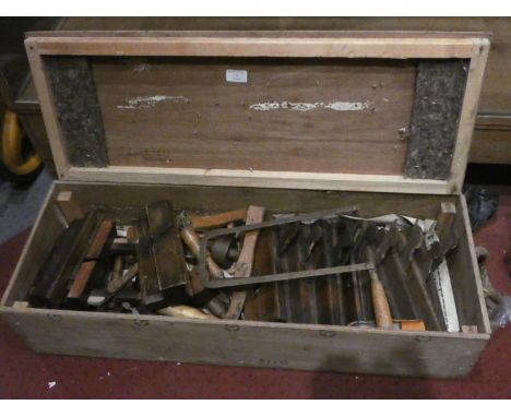 A collection of vintage wood workers tools in a scratch built wooden chest including-block planes, bench vice, stanley &amp; 
