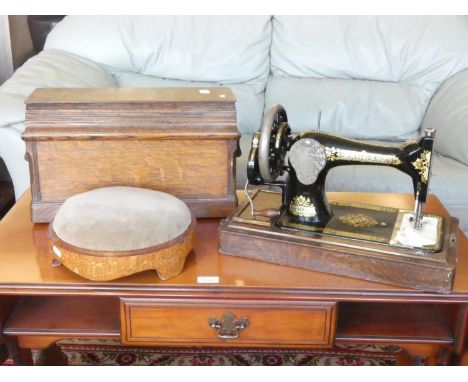 A manual oak cased Singer sewing machine together with a inlaid Edwardian foot stool.(2)