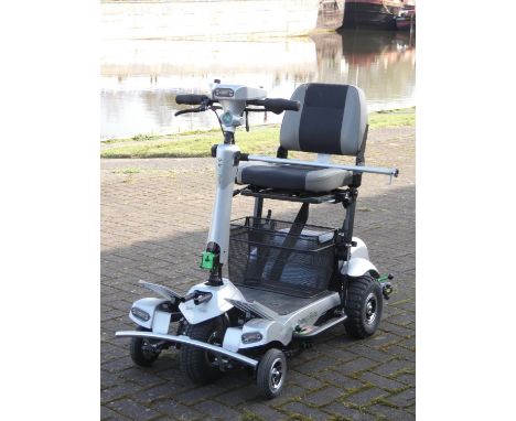 A Quingo Flyte mobility scooter, complete with battery charger