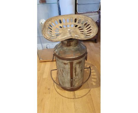 An Industrial style milk churn with tractor seat bar stool.