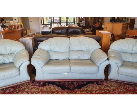 A pale green leather 3 piece suite, comprising 2 seater sofa and 2 armchairs. 