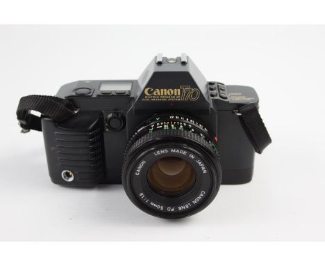 Canon T70 SLR Film Camera w/ Canon FD 50mm F/1.8 Lens  The camera is WORKING and in a good condition Winds and fires as shoul