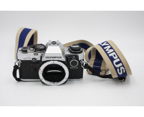 Olympus OM10 SLR Film Camera Body Only w/ Olympus Strap w/ Manual Adapter (Allows User to Change Shutter Speeds)  The camera 