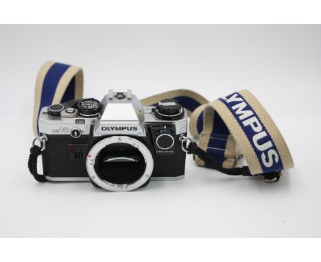 Olympus OM10 SLR Film Camera Body Only w/ Olympus Strap w/ Manual Adapter (Allows User to Change Shutter Speeds)  The camera 