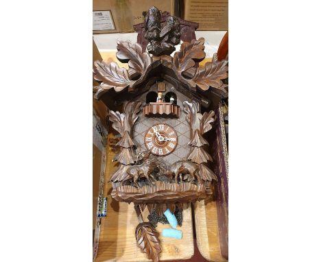 A Bavarian cuckoo clock with owl pediment and other clocks