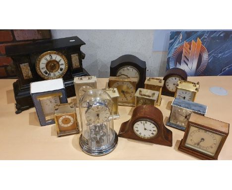 A collection of various mantle and carriage clocks, including an Elliott clock lacking top 
