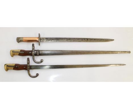 Two 1875 bayonets "Mre D'armes de St. Etienne", one with original scabbard. WW1 Lee Enfield bayonet with later edition copper